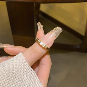 Detailed close-up of a gold-plated bamboo ring with rectangle cat's eye stone and zircons