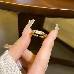 Elegant gold bamboo-style open ring featuring a rectangular opal gemstone and small crystals