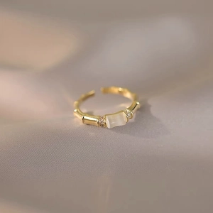 Elegant gold bamboo joint ring with opal gemstone and sparkling zircon accents