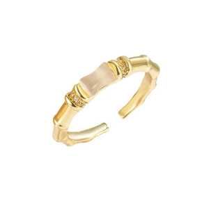 Bamboo style gold adjustable ring with cat eye stone and zircon accents on white background