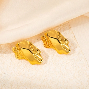 Artistic gold stainless steel butterfly flower earrings on silk fabric for parties