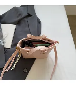 Interior view of pink glossy bucket bag showing spacious storage with zipper pocket
