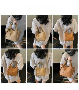 Detailed views of vintage bucket bags in light and dark brown leather with charms