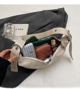Detailed macro view of cream hobo bag with metal eyelets and large interior space