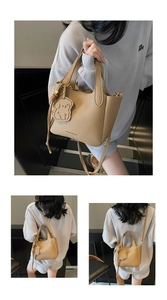 Detail of camel lychee pattern bucket bag with dog charm and detachable strap