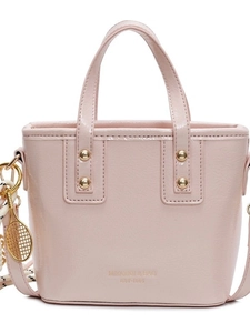 Pink glossy bucket bag with top handle and tennis racket charm shown in a front view