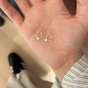 Vue détaillée de boucles d'oreilles créoles en perles d'argent minimalistes