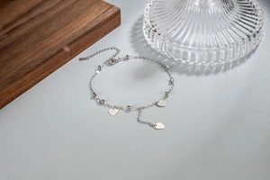 Close-up of S925 sterling silver heart tassel anklet with polished beads and lobster clasp