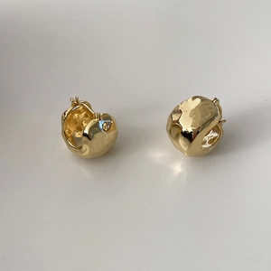 Irregular gold textured chunky hoop earrings with a polished minimalist design for women