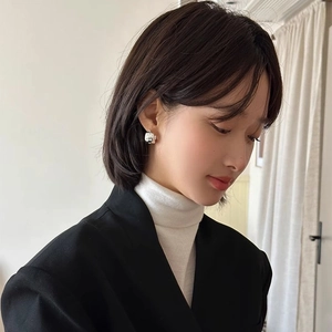 Minimalist irregular thick silver hoop earrings for women shown on a model