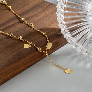 Elegant gold bead anklet with heart-shaped tassels and Y-shaped chain design