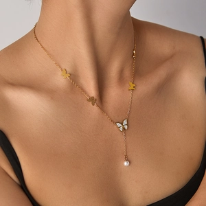 Detail of titanium steel butterfly necklace with pearl and mother-of-pearl pendant