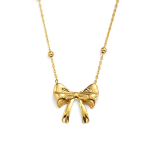 Minimalist gold bow pendant necklace with decorative beads on a delicate chain
