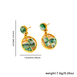 Detailed specs of vintage 18K gold butterfly earrings with green marble texture