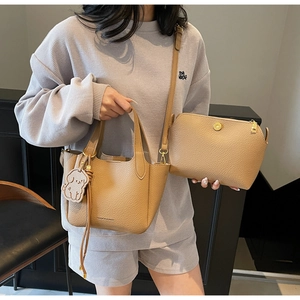 Detail of camel lychee pattern bucket bag and matching mini crossbody pouch set