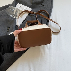 Retro color-block mini bucket bag with embossed texture and adjustable brown leather strap