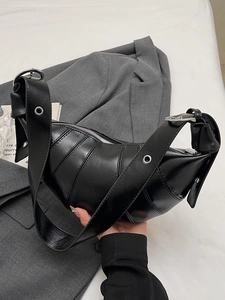 Minimalist black shiny crescent croissant bag with adjustable metal eyelet wide strap