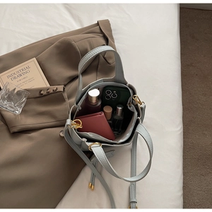 Top view of blue litchi leather bucket bag showing spacious interior with personal items