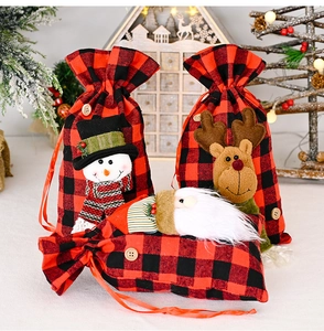 Detailed close-up of Christmas gift bags featuring snowman, reindeer, and Santa motifs