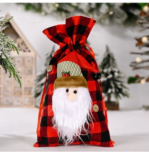 Detailed view of Christmas buffalo plaid gift bag with 3D Santa Claus and plush beard