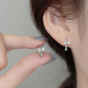 Silver bow knot hoop earrings featuring heart shaped cubic zirconia for women