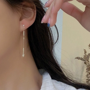 Silver-colored tassel earrings with irregular beads on long chains for women