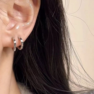 Minimalist silver square geometric hoop earrings with high-polish mirror finish on ear