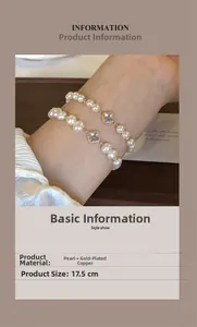Detail of dual-layered pearl bracelet with gold-plated four-leaf clover motifs