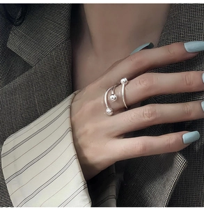 Detail of silver spiral multi-layer ring with bead accents on a model's finger