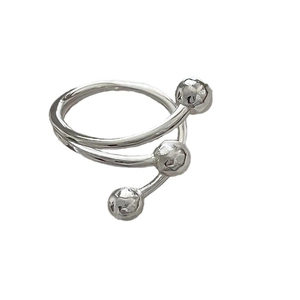 Minimalist silver wrap ring with three layered spiral bands and decorative metal beads