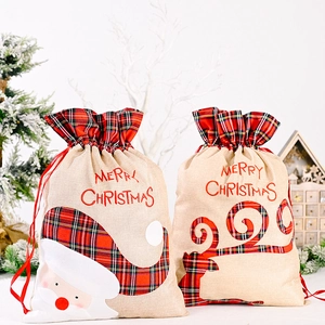 Detail of Christmas gift bags with Santa Claus, reindeer applique and red buffalo plaid