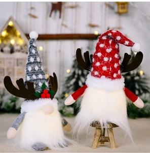 Detail of light-up Christmas gnomes with reindeer antlers and warm glowing LED beards