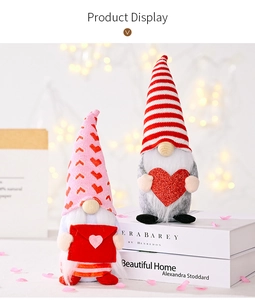 Close-up of plush Valentine gnomes with hearts and envelopes on a warm lit display