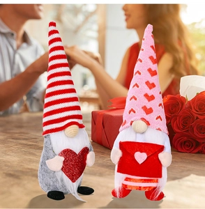 Close-up of Valentine Gnomes featuring heart and envelope decorations on a wooden table