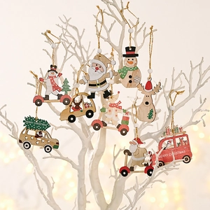 Detailed view of Christmas wooden ornaments with Santa and reindeer on white branches