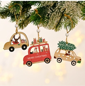 Detailed view of hand-painted wooden Christmas car pendants hanging on festive pine branches