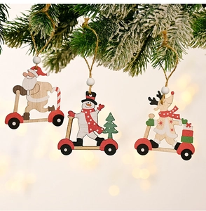 Detailed view of three cartoon wooden Christmas ornaments hanging on snowy pine branches