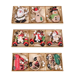 Detail of painted wooden Christmas ornaments with snowman and elk in a rustic wooden tray
