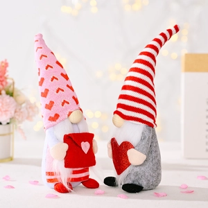 Valentine's Day Gnomes set with heart envelope and knit hats on floral bokeh background