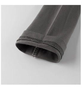 Close-up of neat stitching and fine knit texture on dark grey children's sleeve cuff