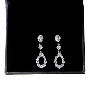 Elegant silver teardrop earrings with white cubic zirconia in a tiered hollow design