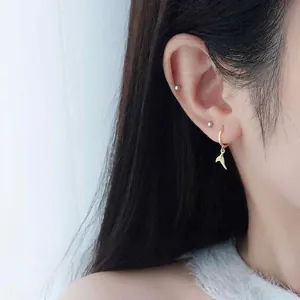 Elegant gold fishtail hoop earrings for women showing a minimalist and stylish aesthetic