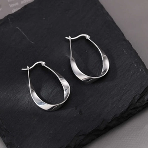 S925 sterling silver twisted Mobius hoop earrings with a high-polished mirror finish