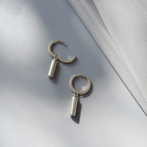 Minimalist silver geometric cylinder drop earrings with pavé stones and glossy finish