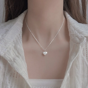 Elegant silver heart pendant necklace with matte finish on a delicate bead chain