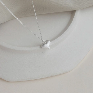 Elegant silver heart pendant necklace with matte finish on minimalist link chain