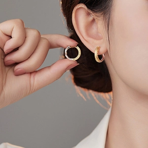 Two-tone silver and gold textured hoop earrings with retro vintage metal splicing