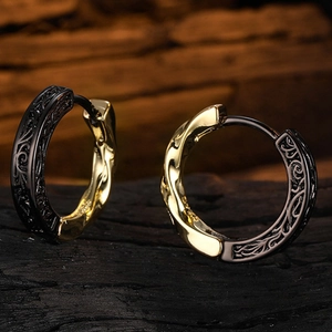 Vintage textured hoop earrings with black and gold contrast and embossed vine patterns