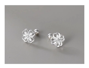 Detailed close-up of hollow clover stud earrings with secure screw-back ball closures