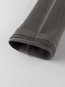 Close-up of dark grey long-sleeve knit cuff showing high-quality stitching and texture